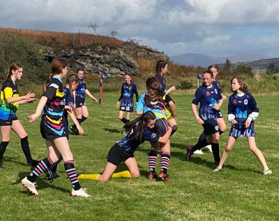Girls team playing rugby